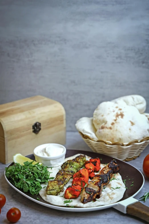 a plate filled with chicken, bread and vegetables