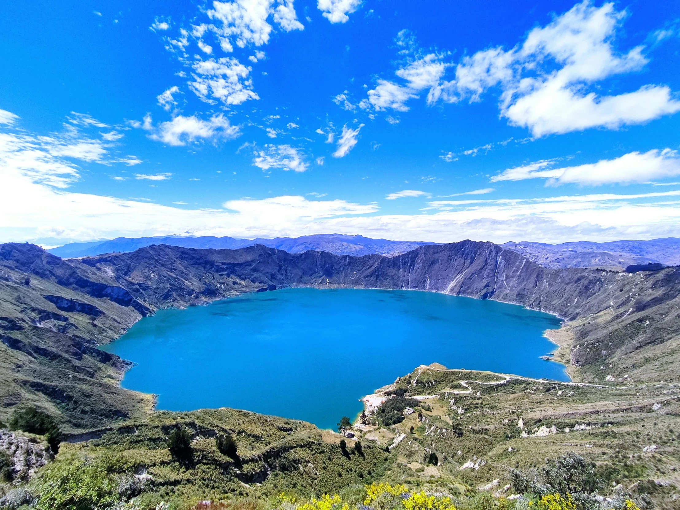 a large body of water surrounded by mountains and trees