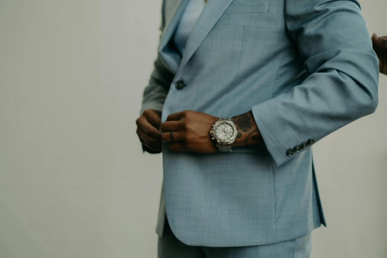 a man wearing a blue suit jacket and watch