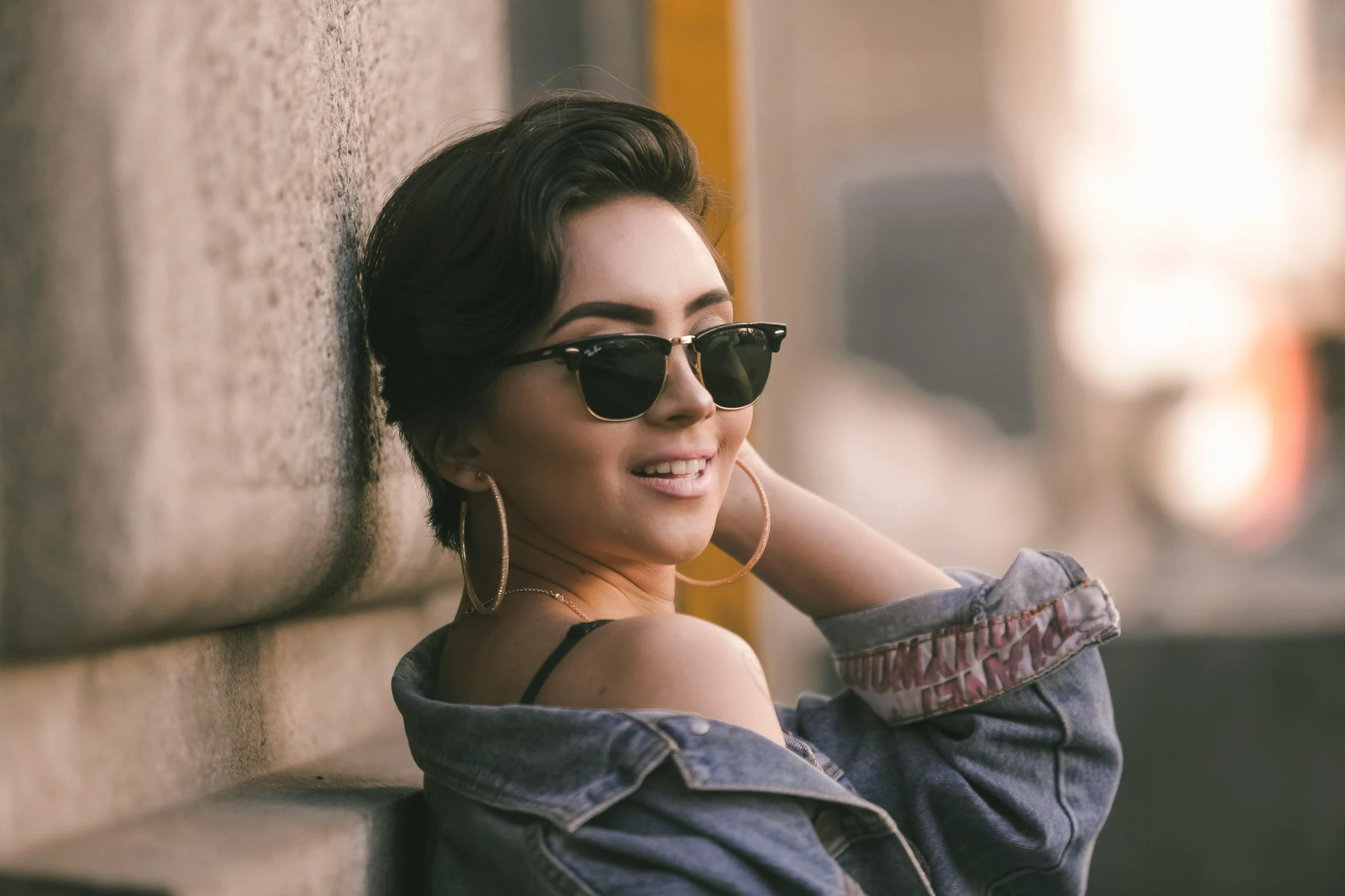 an image of woman wearing sunglasses smiling