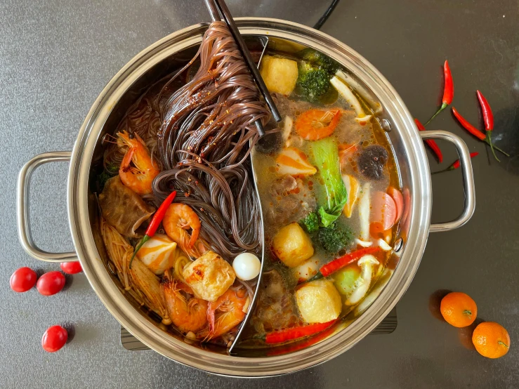there is a stew with shrimp and vegetables in the pot