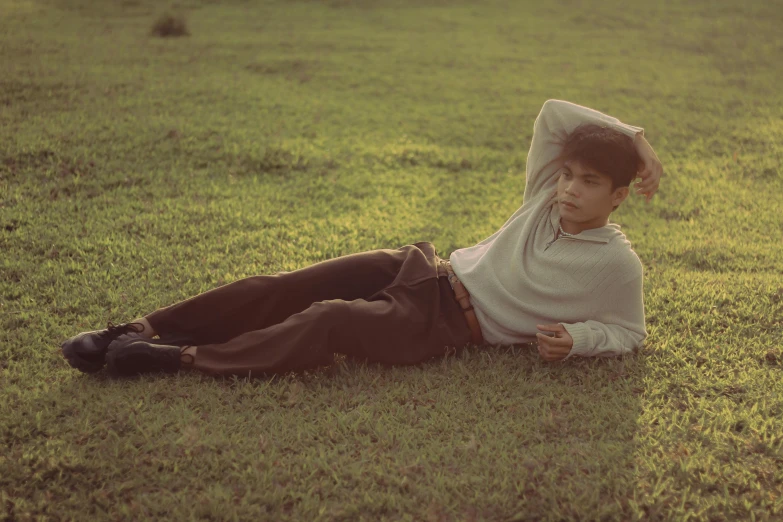 a child lying in the grass on the ground