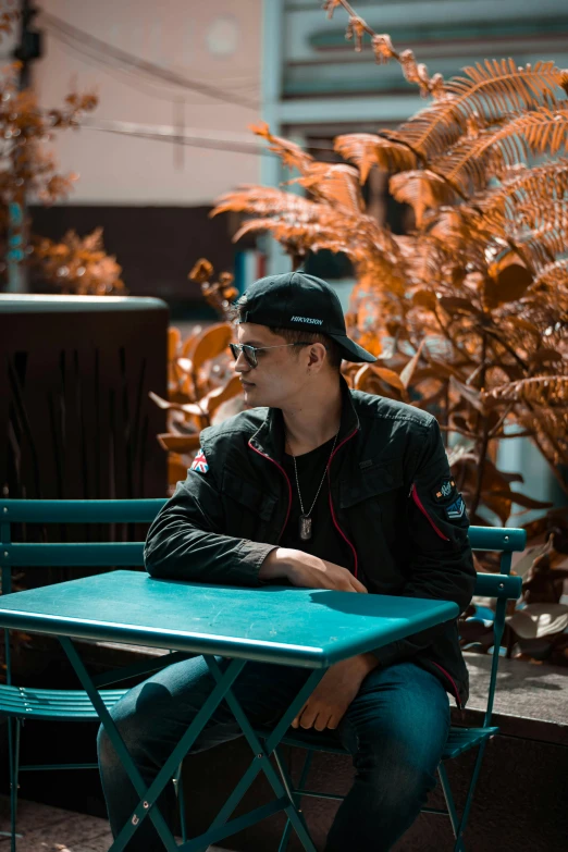 a man is sitting at a table in the street