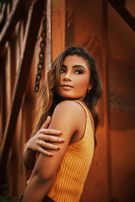 a girl is posing by some stairs