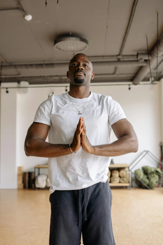 a man who is practicing yoga poses in a room