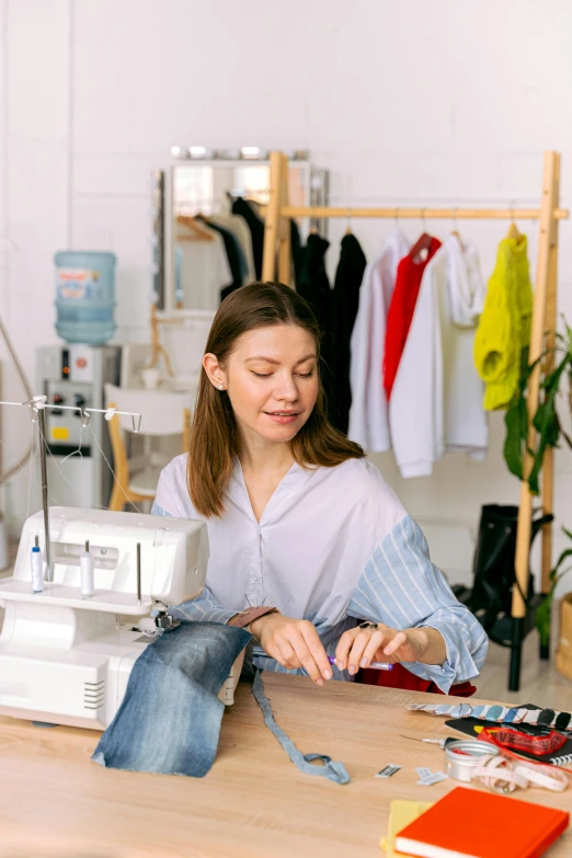 a lady using a sewing machine while at a table