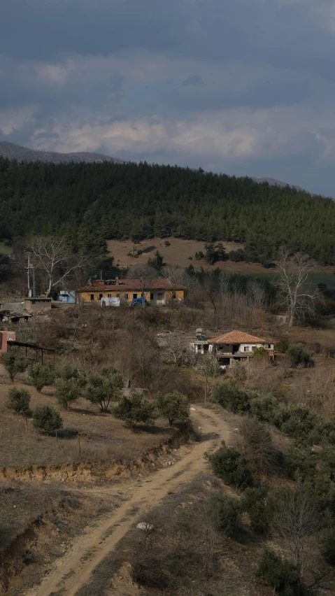 a village on a hill, surrounded by trees