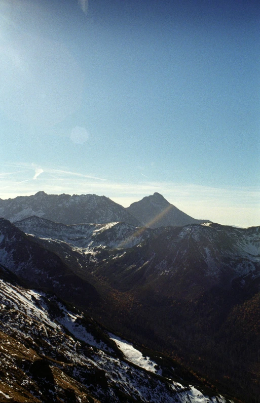 people on skis stand at the top of the mountain