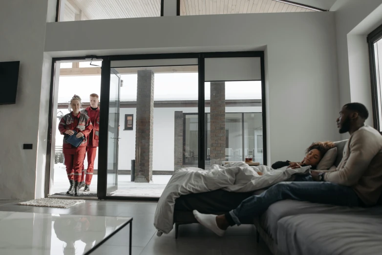 two men and women looking in doors at one another