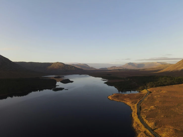 the aerial view of a lake surrounded by mountains