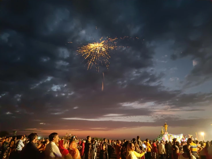 people are watching fireworks during a festival