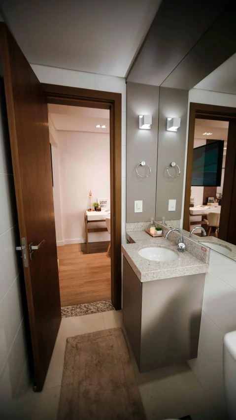 a view into a bathroom with double sinks and toilet