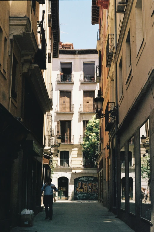 an narrow alley with several tall buildings in the background