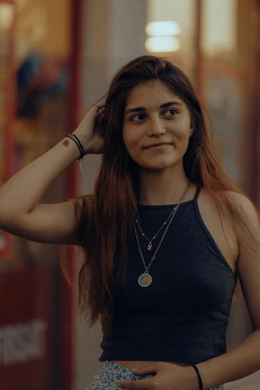 a girl in black top holding her hair up