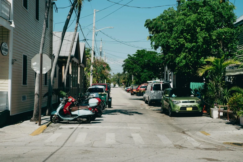 an old motorcycle parked in a very narrow town