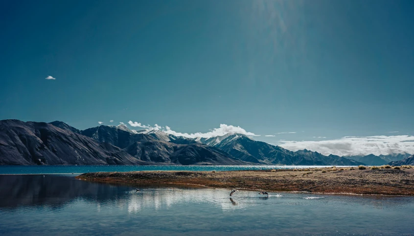 the mountain view is shown from across the water