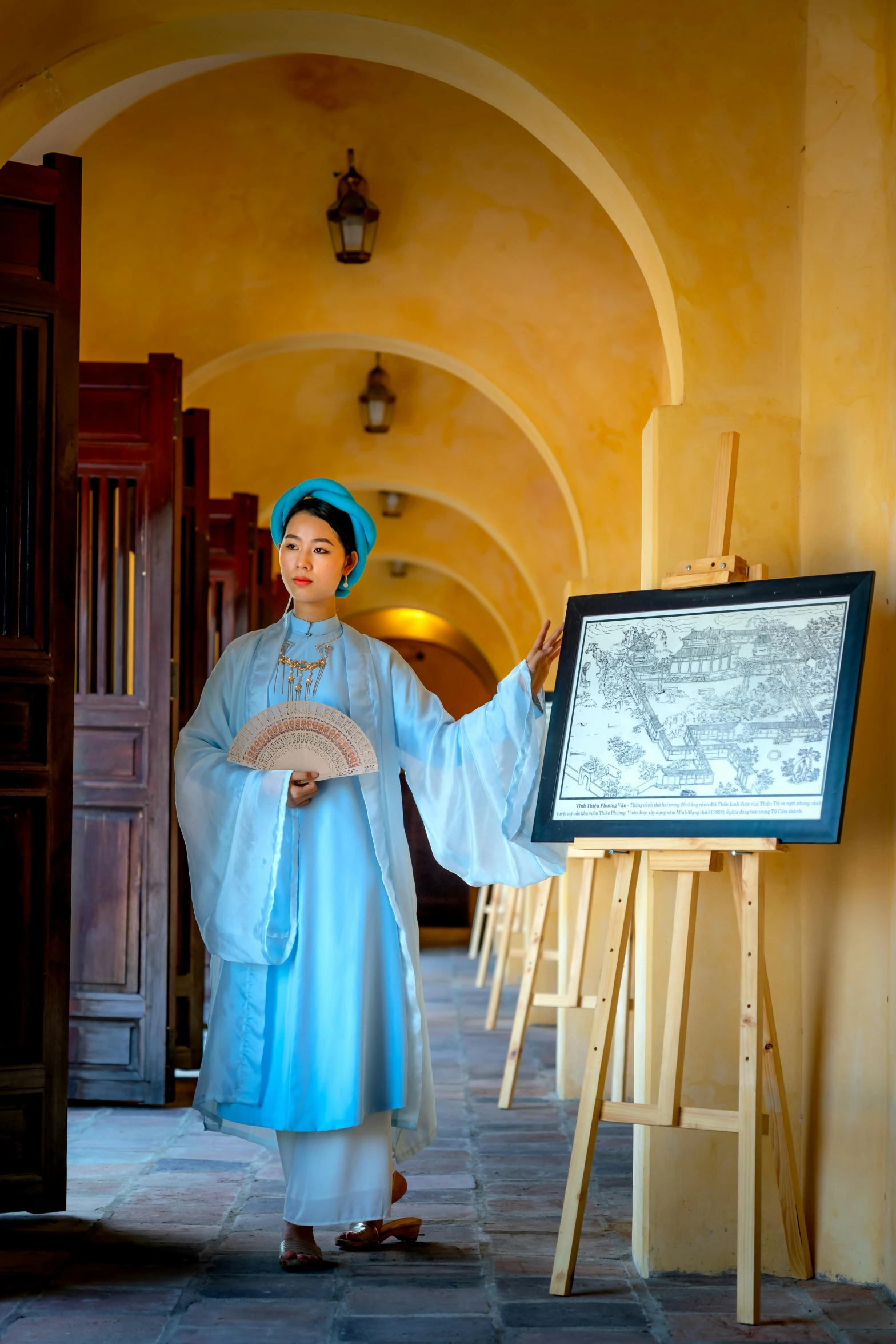 a young lady standing in front of an artwork presentation