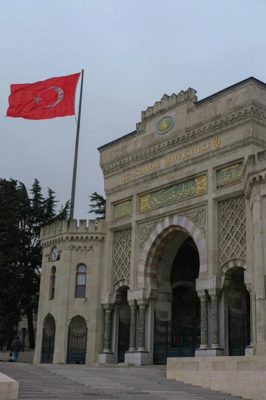 a red flag is flying over a gated entrance