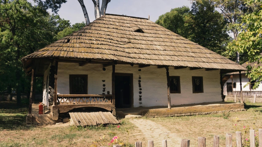 old house with a straw roof and wooden steps