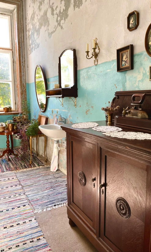 a wooden dresser sitting inside of a bathroom