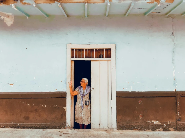 a man in a door way to another building