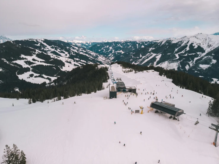 a ski resort with people skiing and snowboarding