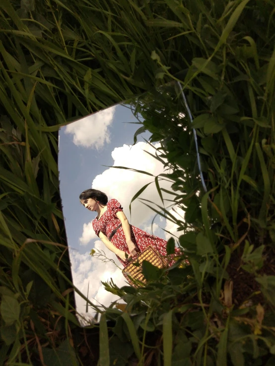 a mirror that has a reflection of a woman in it