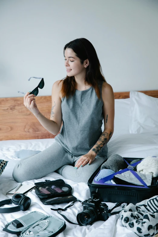 the woman is sitting in bed with many other items on her