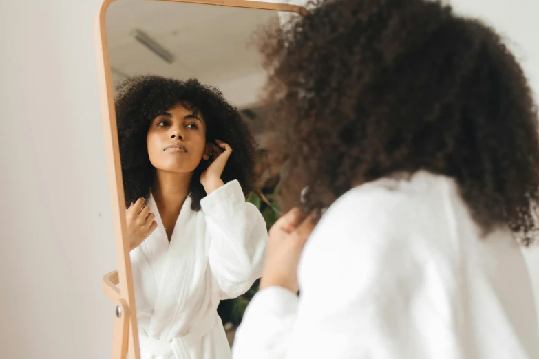 a person standing in front of a mirror holding their cell phone