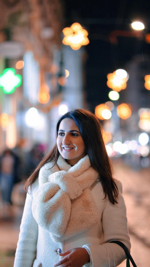 a woman with a hand bag is walking down the street