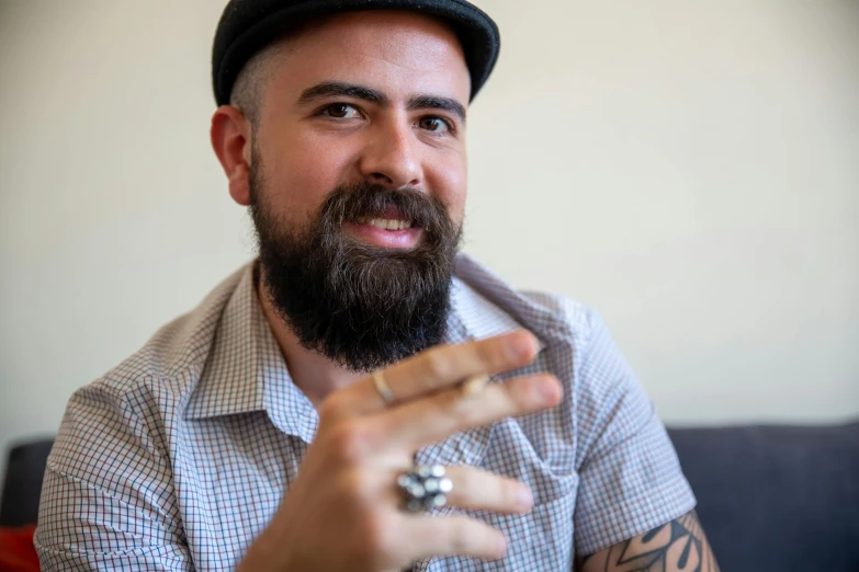 a close up of a person with a mustache and a hat