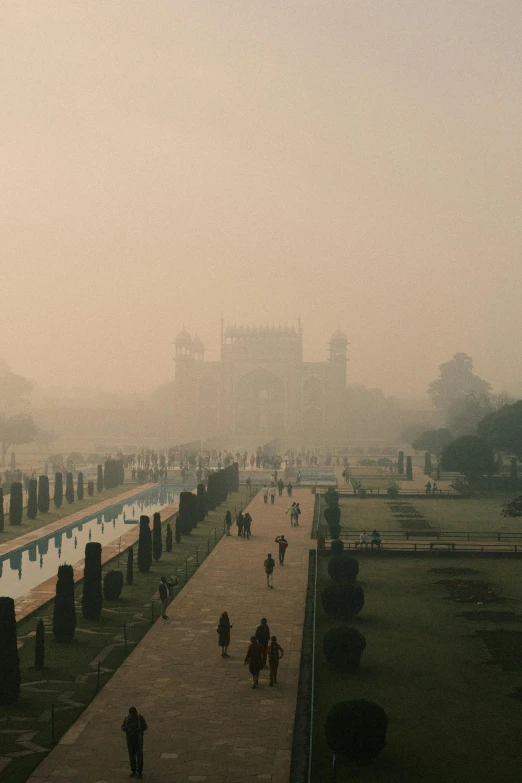 a very long pathway in the park between two large buildings