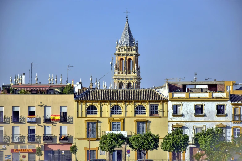 a tall building with a tower that is standing in the middle of the town