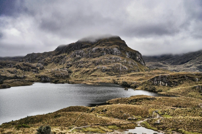 a mountain landscape with lake, mountains and trees in the background