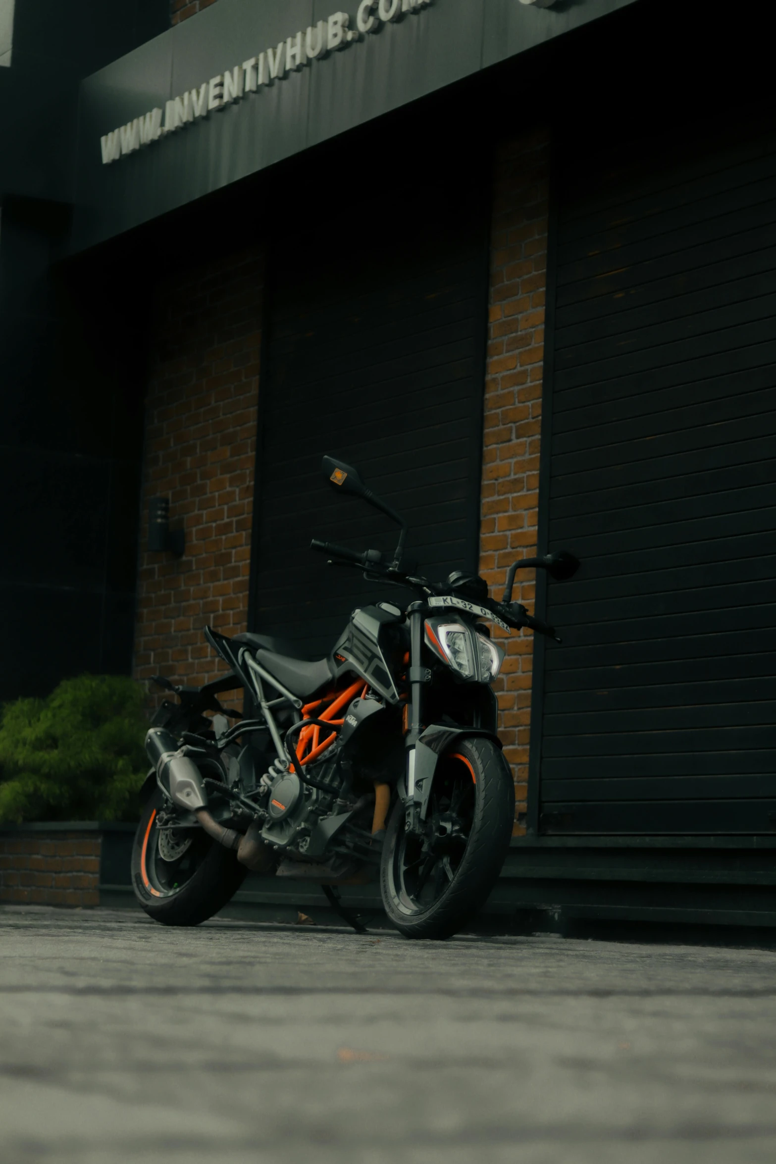 a black and orange motorcycle parked outside a business