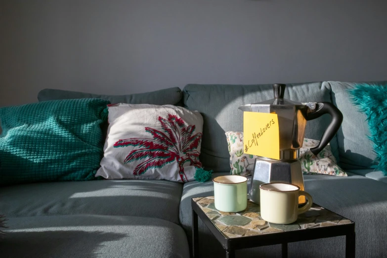 an up - close s of a sofa with two coffee mugs on it