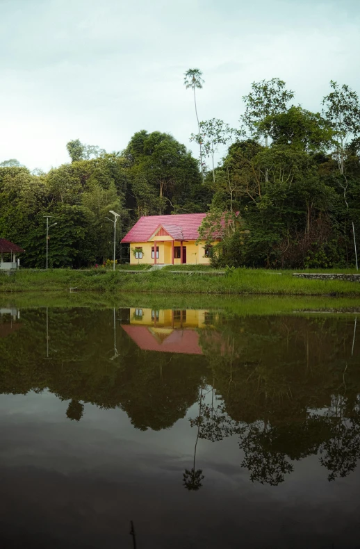 a small house that is sitting in the middle of a lake