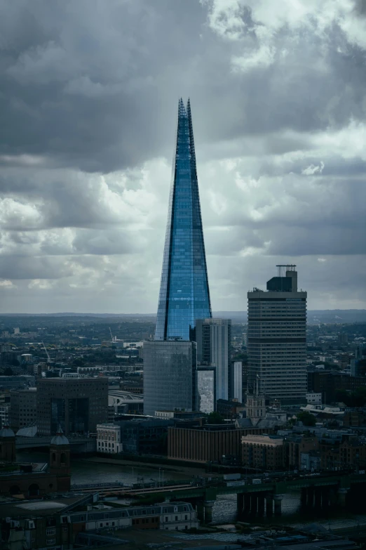 the building is blue and there are some dark clouds in the background