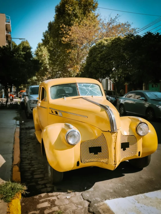 a yellow truck that is parked on a street