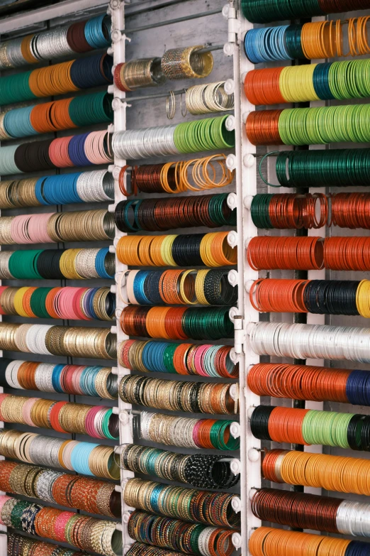 large collection of brightly colored threads and tapes for sewing