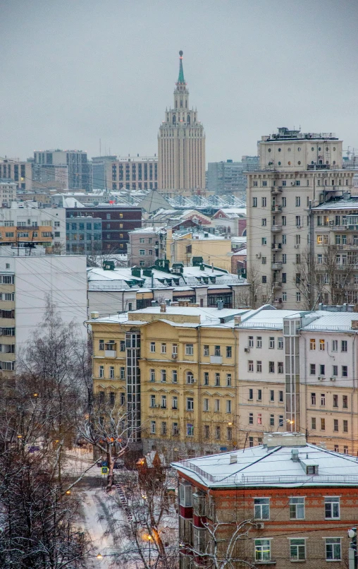 a city with snow and trees in the foreground