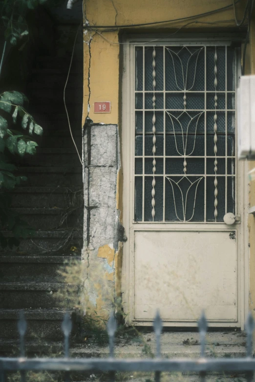 a door with glass is on a dirty side walk