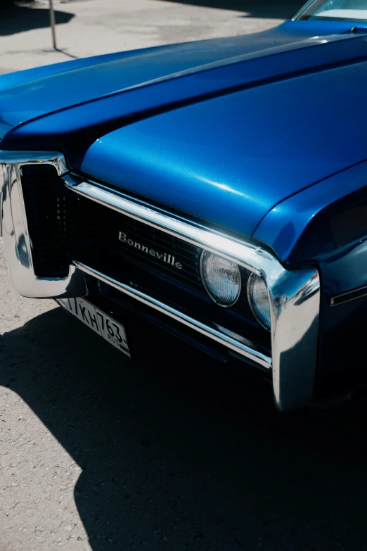 the hood and headlights of an old blue car