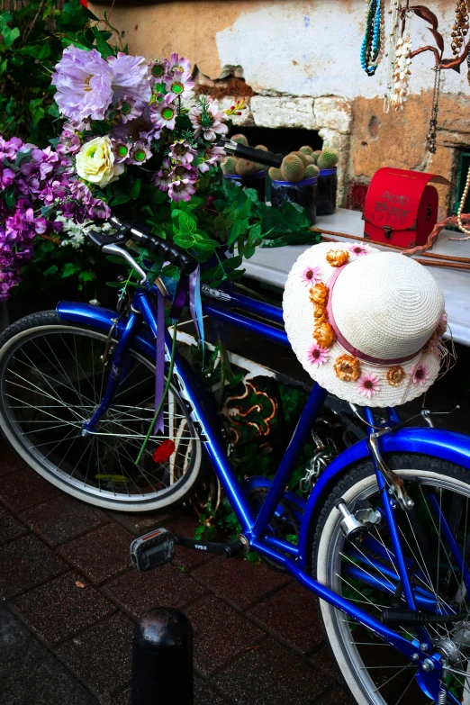 the blue bicycle is decorated with flowers and a pillow