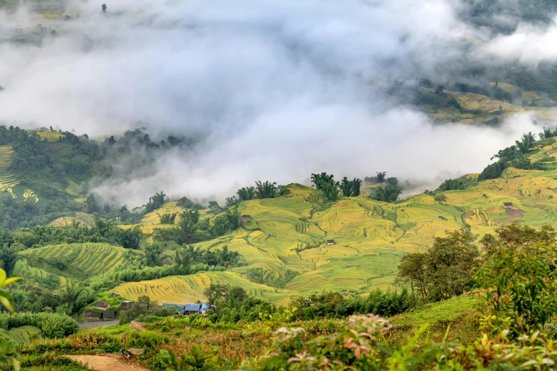 mountains covered in green grass with clouds