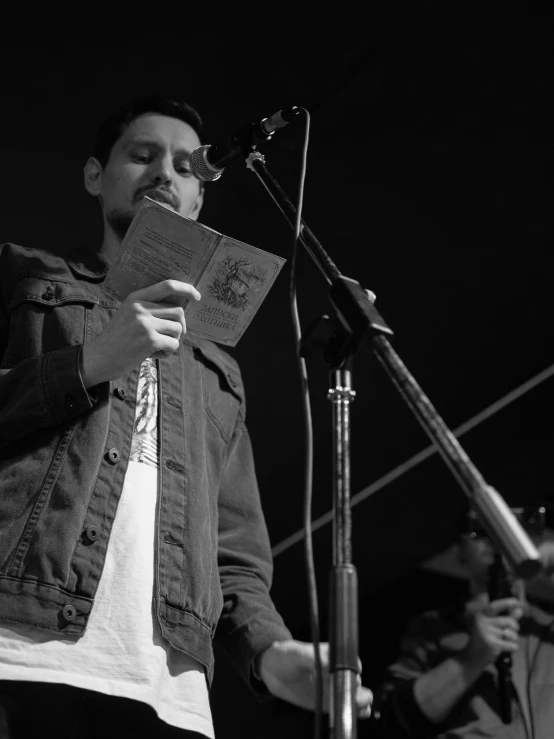 a man that is standing next to a microphone