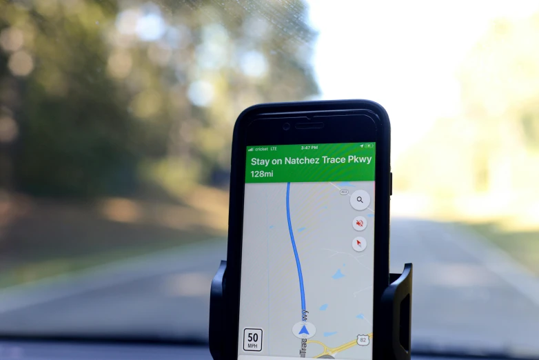 a cell phone attached to the dashboard of a car