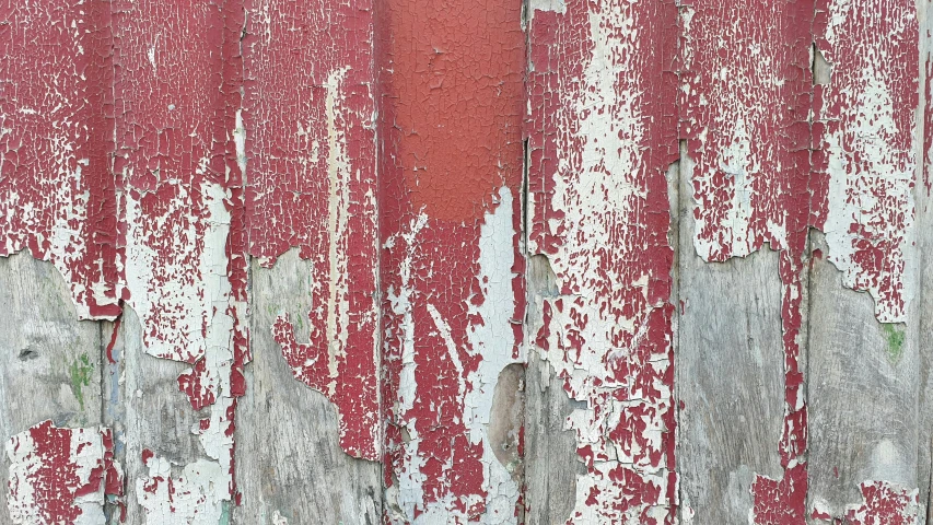 an old peeling wooden door with a bunch of paint chipping on it