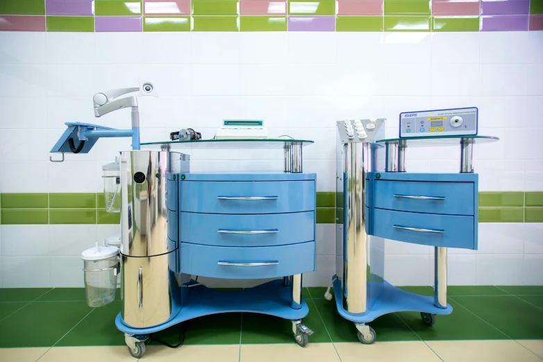 two medical equipment sitting side by side on top of a floor