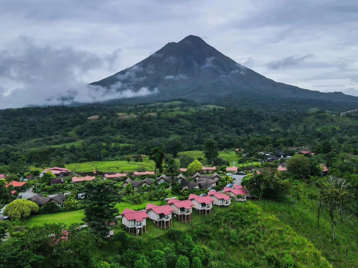 a very pretty small village with a mountain in the background